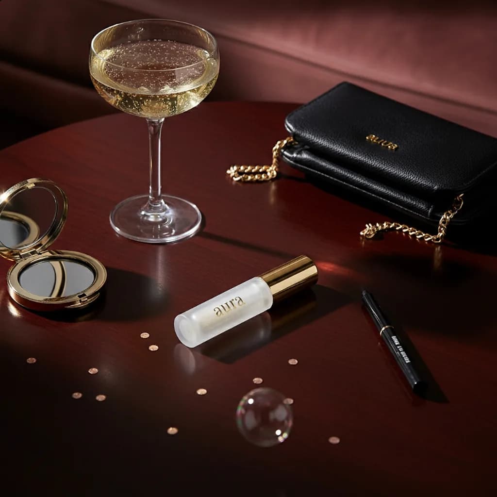 Aura lip gloss on a lounge table